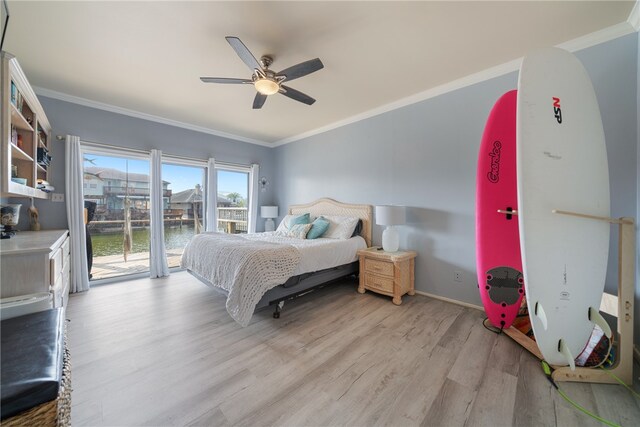 bedroom featuring access to outside, light hardwood / wood-style floors, ceiling fan, and ornamental molding