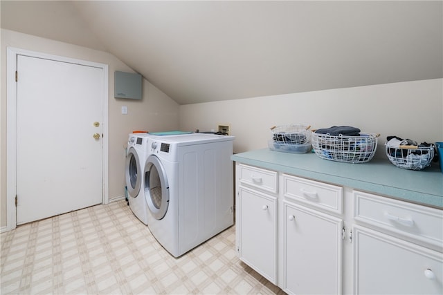 washroom with cabinets and washing machine and clothes dryer