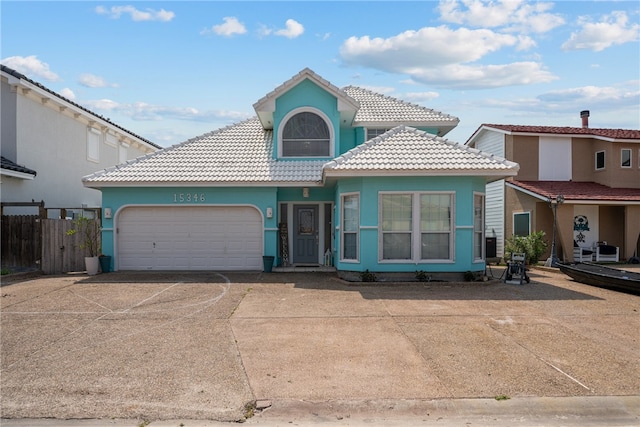 mediterranean / spanish-style home with a garage