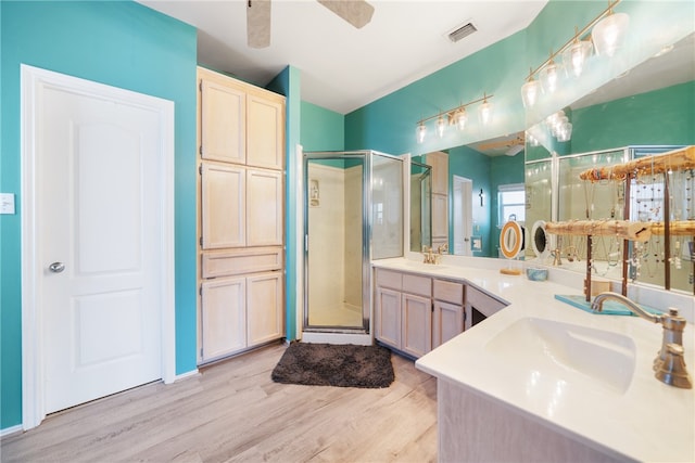 bathroom featuring walk in shower, ceiling fan, vanity, and hardwood / wood-style flooring