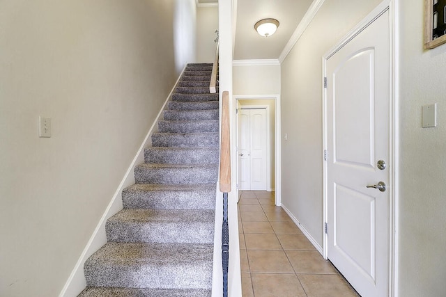 stairs with crown molding and tile patterned floors