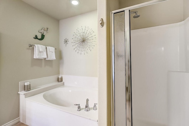 bathroom with separate shower and tub