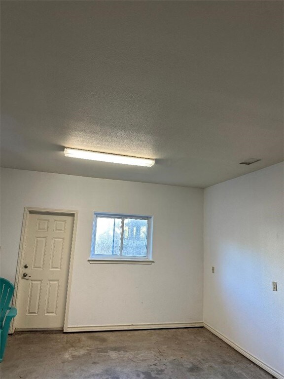 garage featuring water heater and a garage door opener