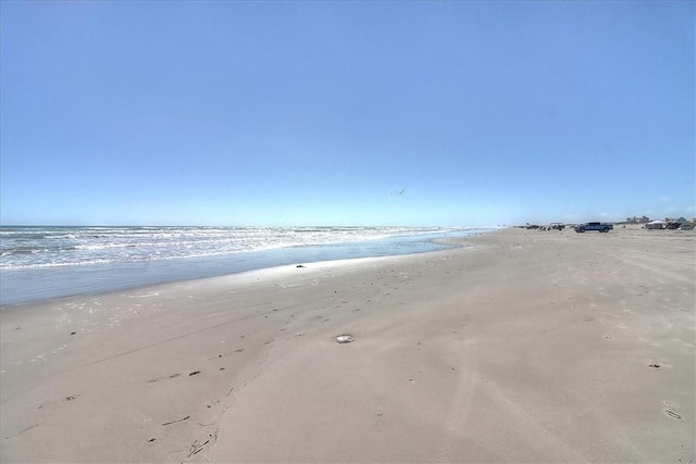 property view of water featuring a beach view