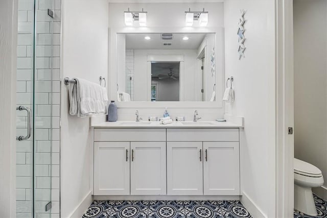 full bath featuring a stall shower, a sink, toilet, and baseboards