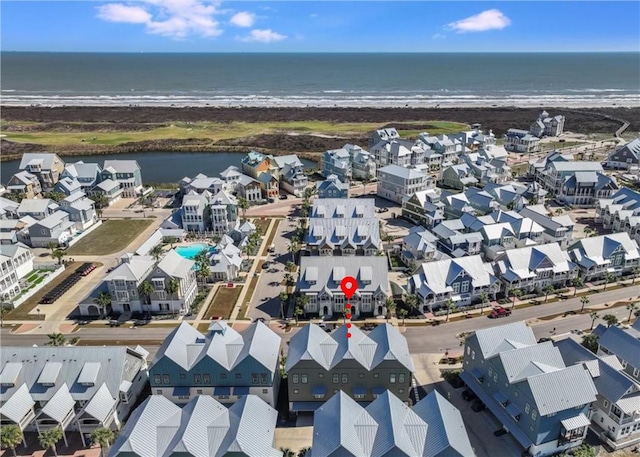 aerial view featuring a water view, a residential view, and a view of the beach