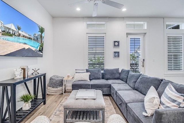 living room featuring a ceiling fan, recessed lighting, and light wood-style flooring