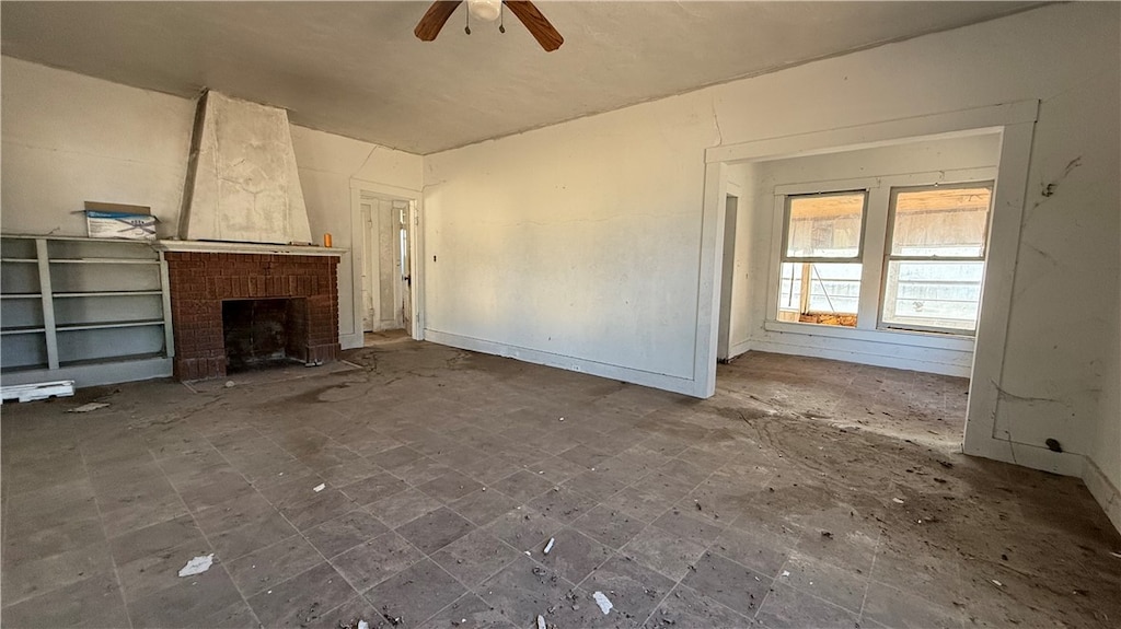 unfurnished living room featuring a fireplace and ceiling fan