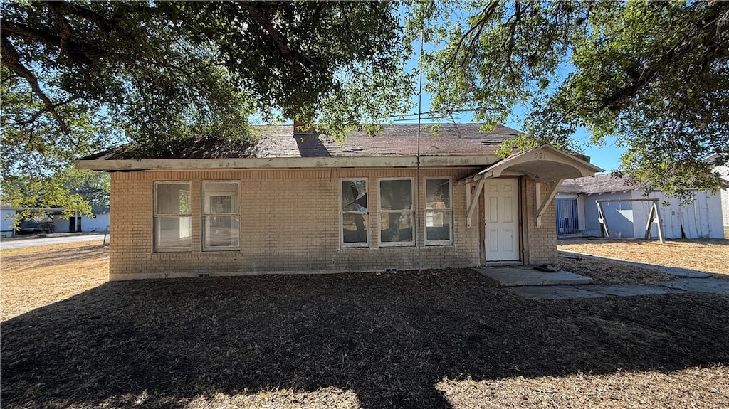 view of front of house with a shed