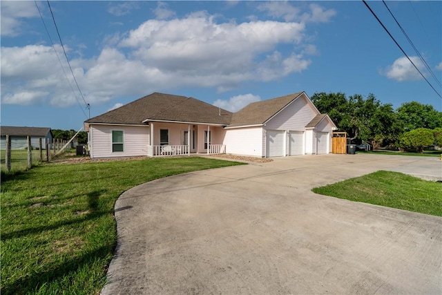 ranch-style house featuring a front yard, covered porch, fence, and driveway