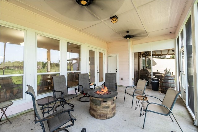 sunroom / solarium featuring a ceiling fan and a wealth of natural light