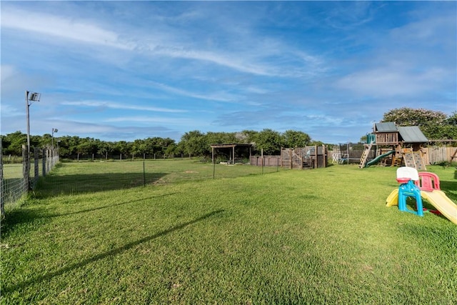 view of yard with fence and a playground