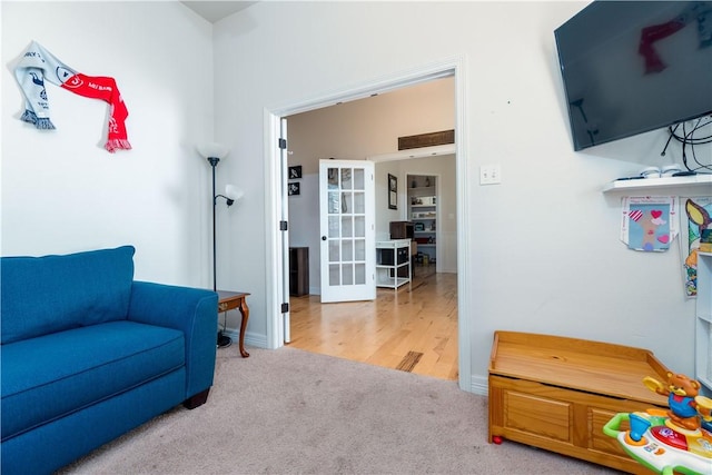 living area with carpet floors and french doors