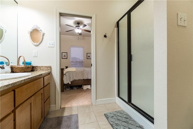 full bath with ceiling fan, tile patterned flooring, connected bathroom, vanity, and a shower stall