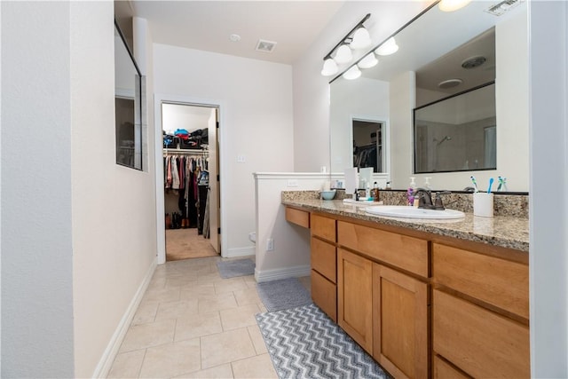 bathroom with tile patterned flooring, visible vents, baseboards, and vanity