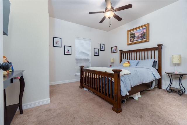 bedroom featuring light carpet, ceiling fan, and baseboards