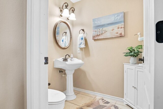 122 Bay Ct, Aransas Pass, TX 78336 - bathroom with tile patterned flooring, toilet, and baseboards