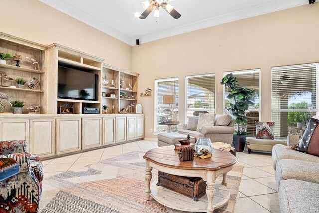 122 Bay Ct, Aransas Pass, TX 78336 - living room with light tile patterned floors, crown molding, ceiling fan, plenty of natural light, and a towering ceiling