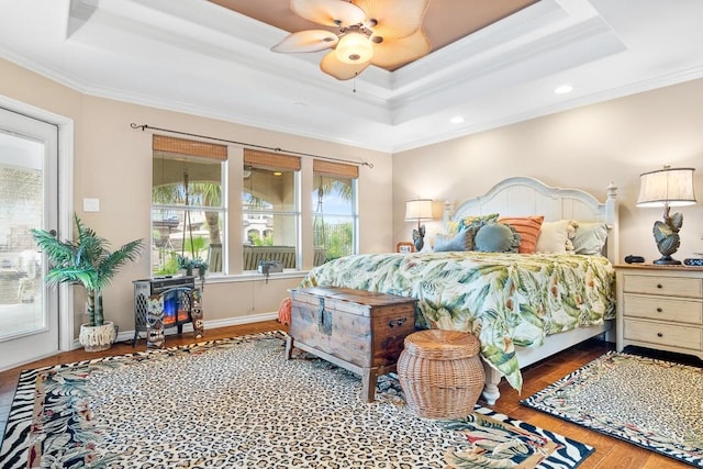 122 Bay Ct, Aransas Pass, TX 78336 - bedroom with a tray ceiling, ornamental molding, wood finished floors, a ceiling fan, and recessed lighting