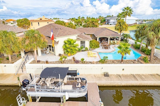 122 Bay Ct, Aransas Pass, TX 78336 - back of property with a patio, a fenced backyard, boat lift, and a water view