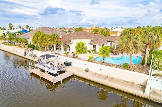 122 Bay Ct, Aransas Pass, TX 78336 - dock featuring a patio, a fenced backyard, an outdoor pool, a water view, and boat lift