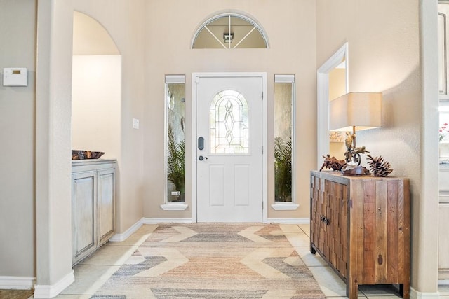 122 Bay Ct, Aransas Pass, TX 78336 - entrance foyer featuring arched walkways, light tile patterned floors, and baseboards