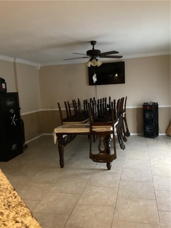 dining room with crown molding, ceiling fan, and light tile patterned floors