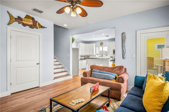 678 Anchor Dr, Port Aransas, TX 78373 - living room featuring light wood-style flooring, stairway, ceiling fan, and recessed lighting