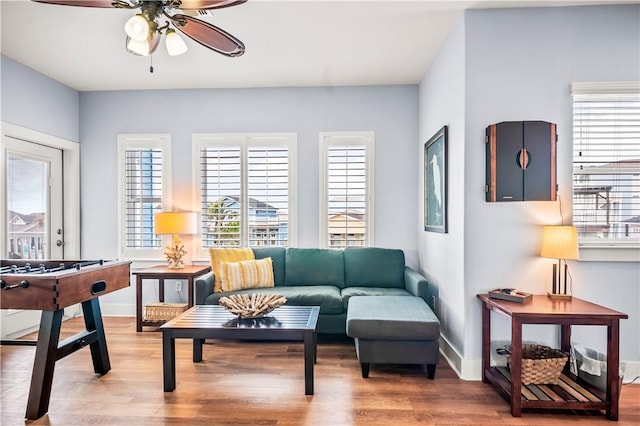 678 Anchor Dr, Port Aransas, TX 78373 - living room featuring ceiling fan, healthy amount of natural light, wood finished floors, and baseboards