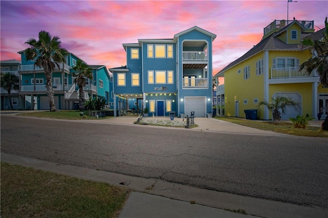 678 Anchor Dr, Port Aransas, TX 78373 - view of front of home featuring driveway, a garage, a balcony, and a carport