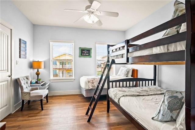 678 Anchor Dr, Port Aransas, TX 78373 - bedroom with wood finished floors, baseboards, and a ceiling fan