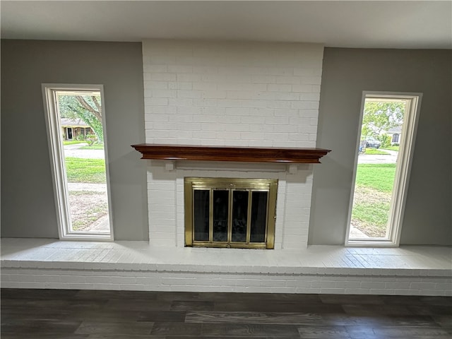 interior details with hardwood / wood-style floors and a brick fireplace