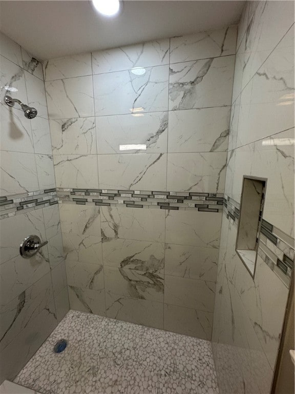 bathroom with a tile shower