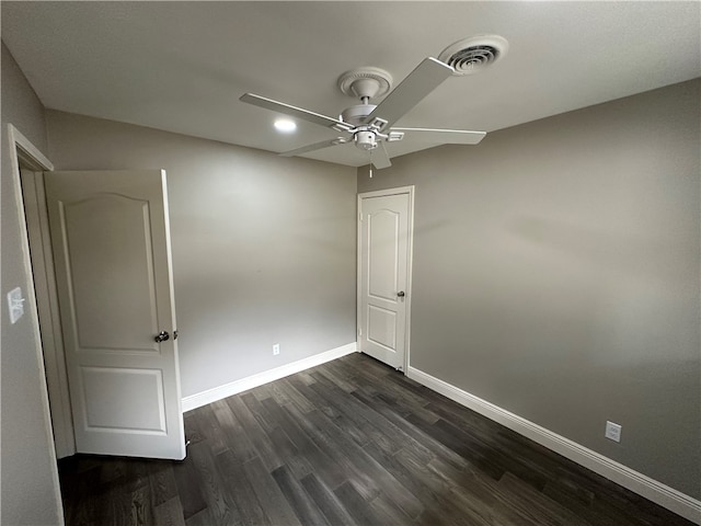 spare room with ceiling fan and dark hardwood / wood-style floors