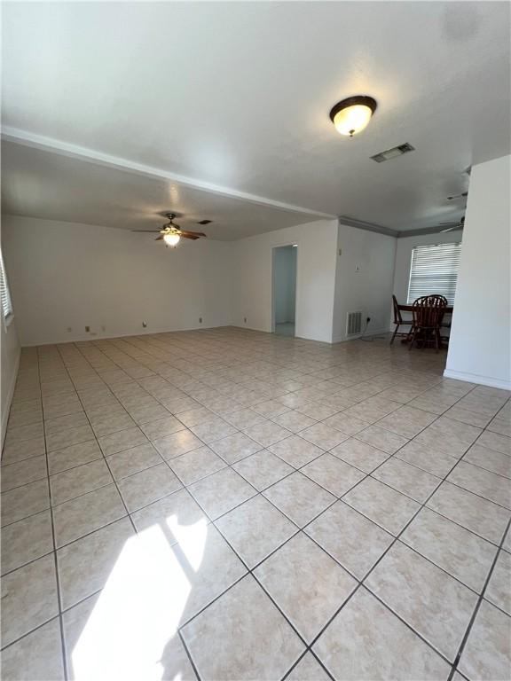 unfurnished room with visible vents, ceiling fan, and light tile patterned flooring