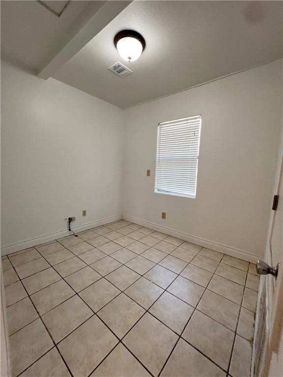 unfurnished room featuring visible vents, baseboards, and light tile patterned flooring