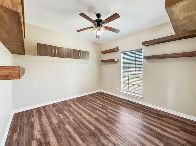 spare room featuring dark hardwood / wood-style floors and ceiling fan