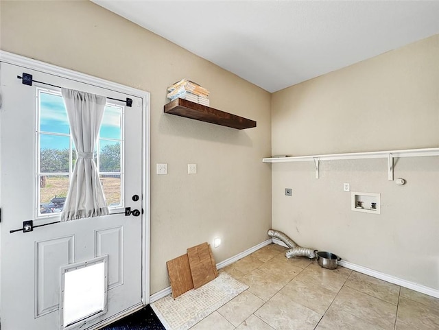 washroom with hookup for an electric dryer, hookup for a washing machine, and light tile patterned flooring