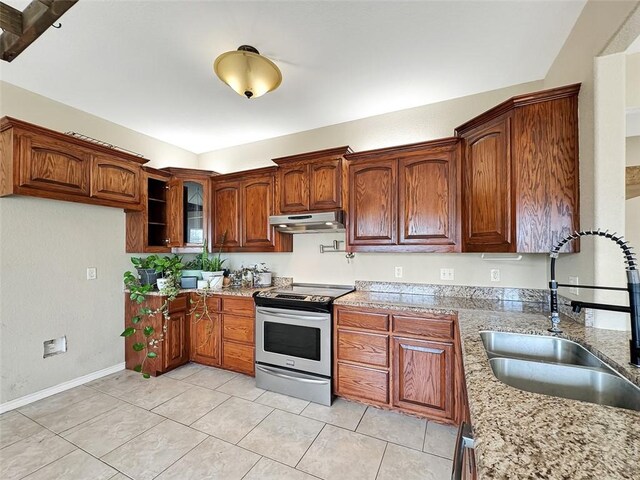 kitchen featuring electric stove, light stone countertops, sink, and light tile patterned flooring