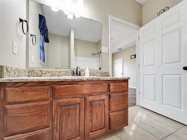 bathroom with tile patterned flooring and vanity