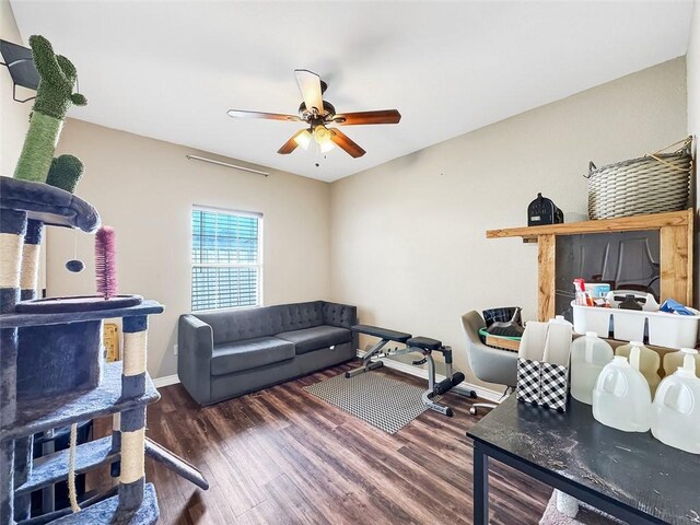 living room featuring dark hardwood / wood-style flooring and ceiling fan