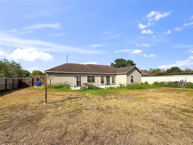 back of house featuring a yard and a patio