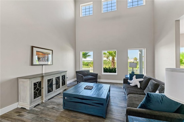 110 Keewaydin Ln, Port Aransas, TX 78373 - living room featuring a high ceiling, healthy amount of natural light, and dark wood-type flooring
