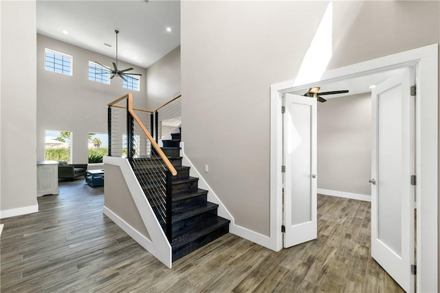 110 Keewaydin Ln, Port Aransas, TX 78373 - staircase featuring ceiling fan, plenty of natural light, wood finished floors, a high ceiling, and recessed lighting