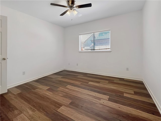 empty room with dark hardwood / wood-style flooring and ceiling fan