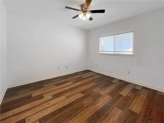 empty room featuring dark wood-type flooring and ceiling fan