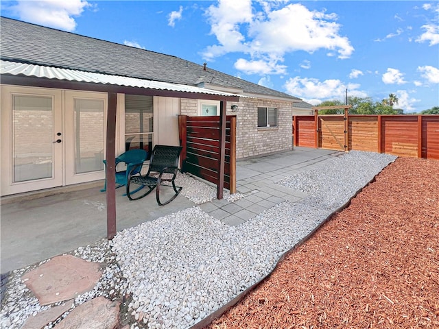 back of property with french doors and a patio area