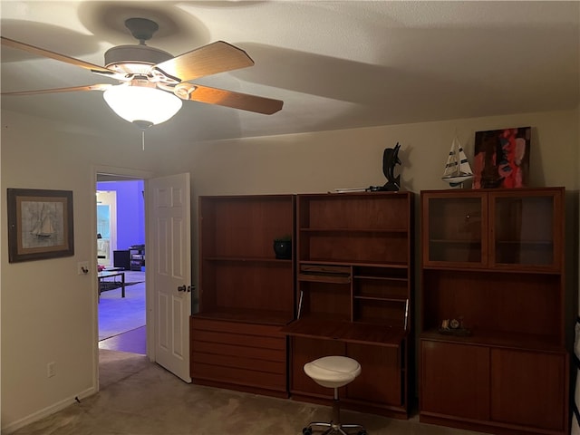 interior space with ceiling fan