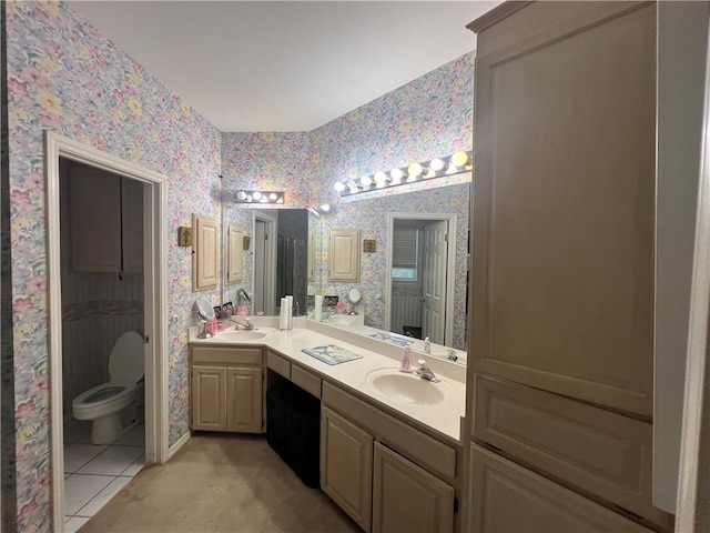 bathroom with tile patterned flooring, vanity, and toilet