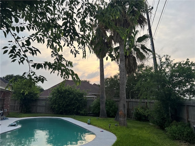 pool at dusk with a yard